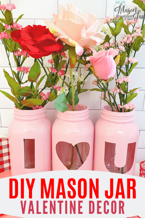 Do you want an easy and beautiful DIY Valentine gift décor idea? This “I Love You” Mason Jar Flowers Centerpiece will be perfect in anyone’s home for the holiday. Whether you are giving these Homemade Valentine’s Day Mason jar gifts to your mom, sister, friend, or coworker, they are sure to appreciate them or gift one to yourself and enjoy it in your own home! ? #valentinemasonjarideas #valentinemasonjarcrafts #valentinemasonjarsdiy #masonjarvalentinegifts 